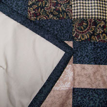 Patchwork Quilt Close Up by Holly